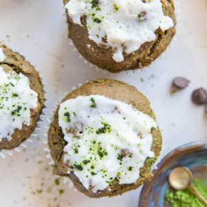 Matcha muffins iced with coconut butter, sprinkled with matcha powder on top.