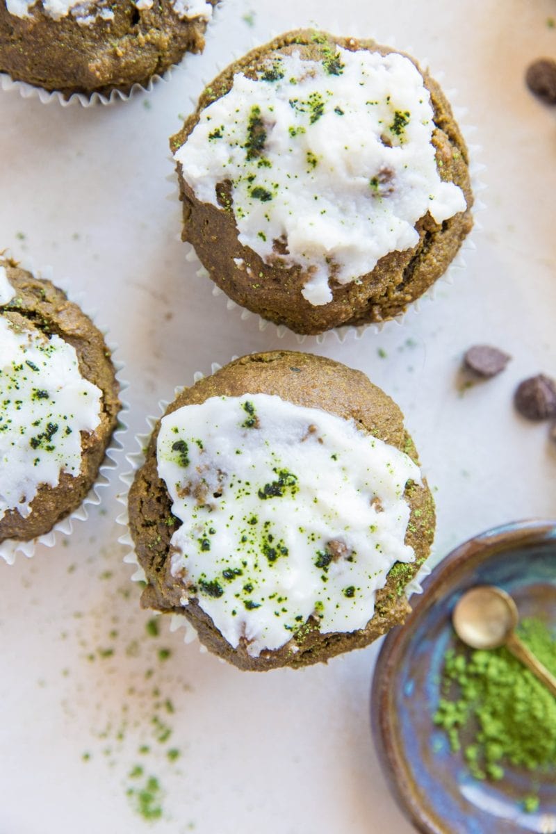 Matcha muffins iced with coconut butter, sprinkled with matcha powder on top.