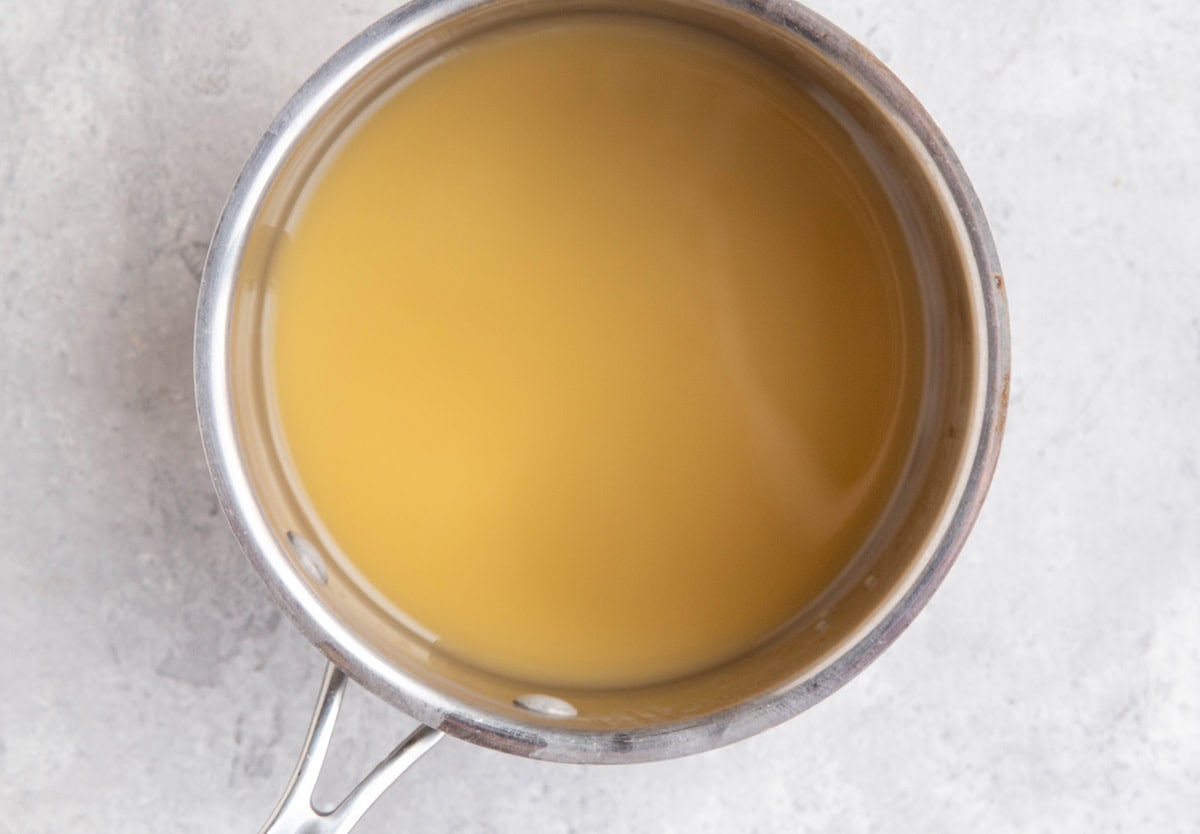 Saucepan full of apple cider to be reduced.