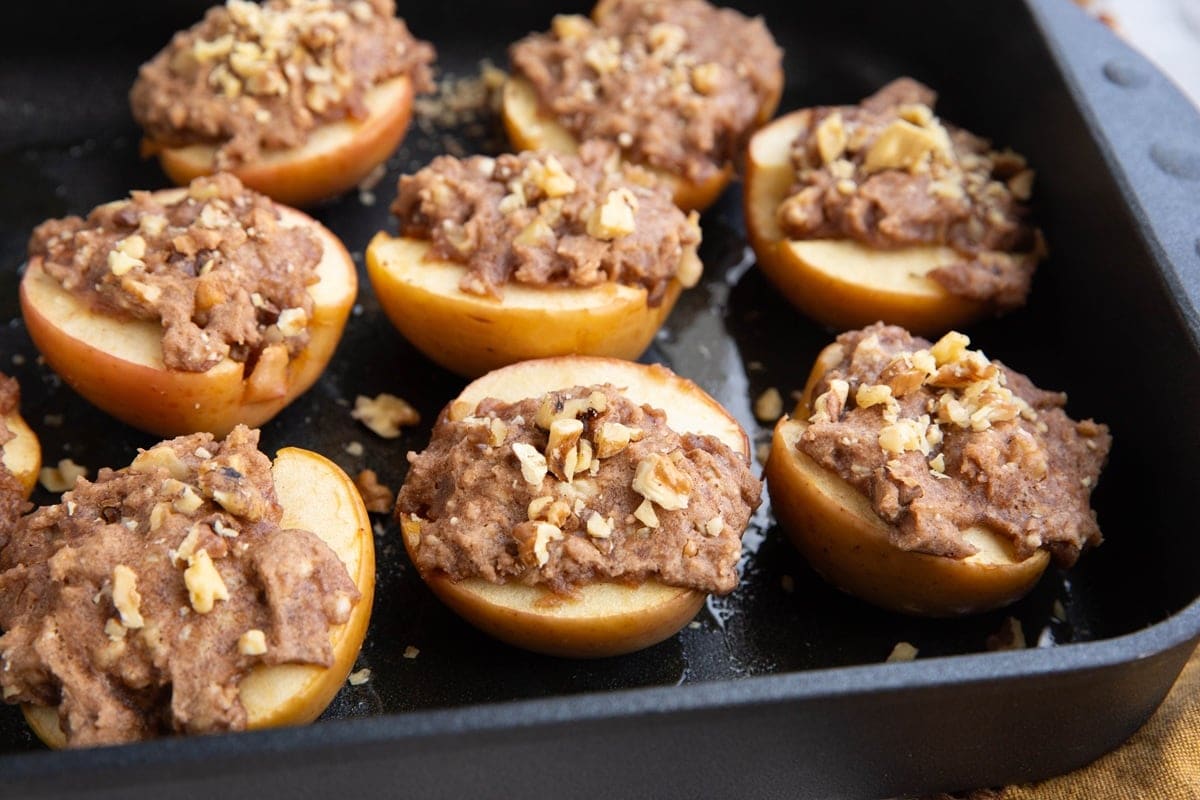 Baked apple halves in a large casserole dish covered with cobbler topping.