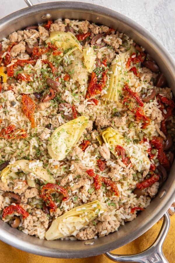 Large skillet full of ground turkey, rice, artichoke hearts, sun-dried tomatoes and more. Freshly cooked and ready to serve.