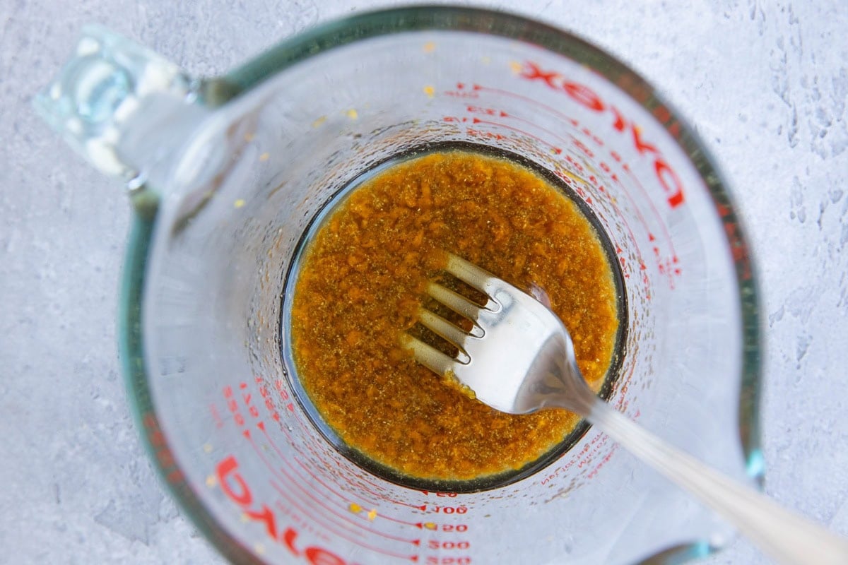 Orange balsamic maple marinade in a measuring cup, ready to use.
