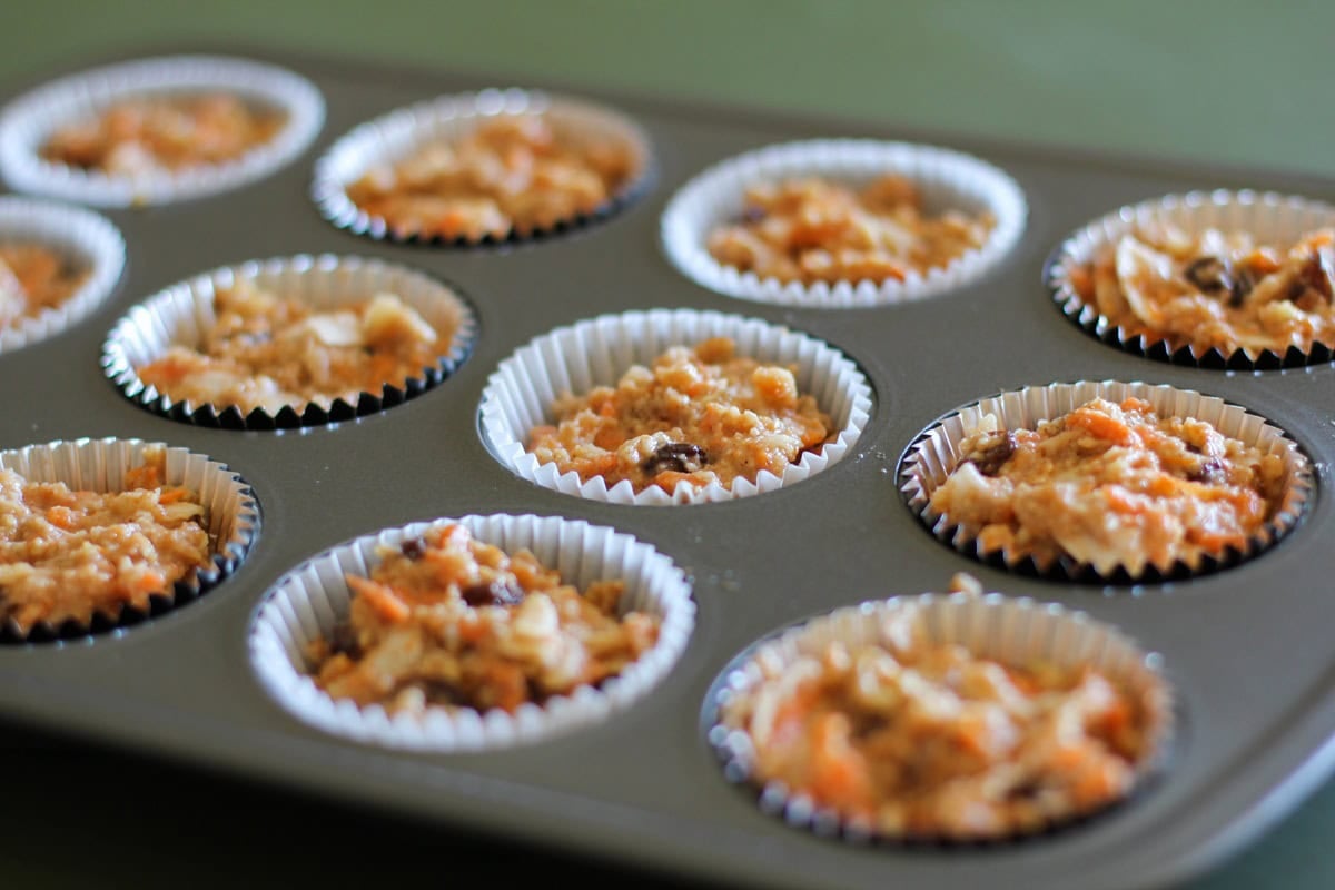 Muffin tray filled with muffin batter for morning glory muffins
