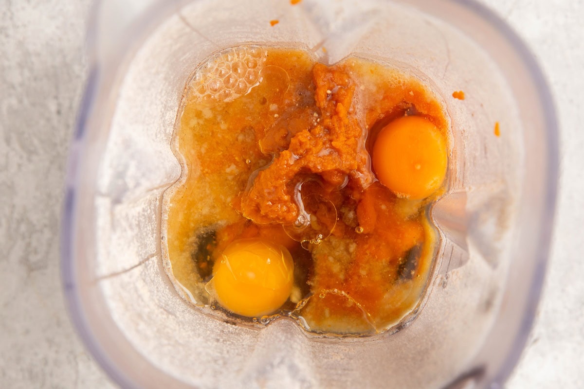 Ingredients for pumpkin waffles in a blender, ready to be blended into batter