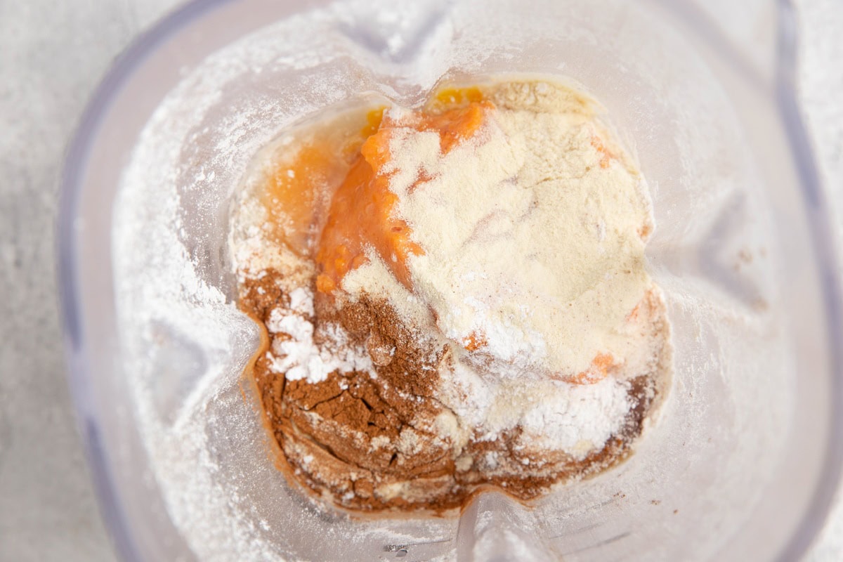 Ingredients for sweet potato waffles in a blender.