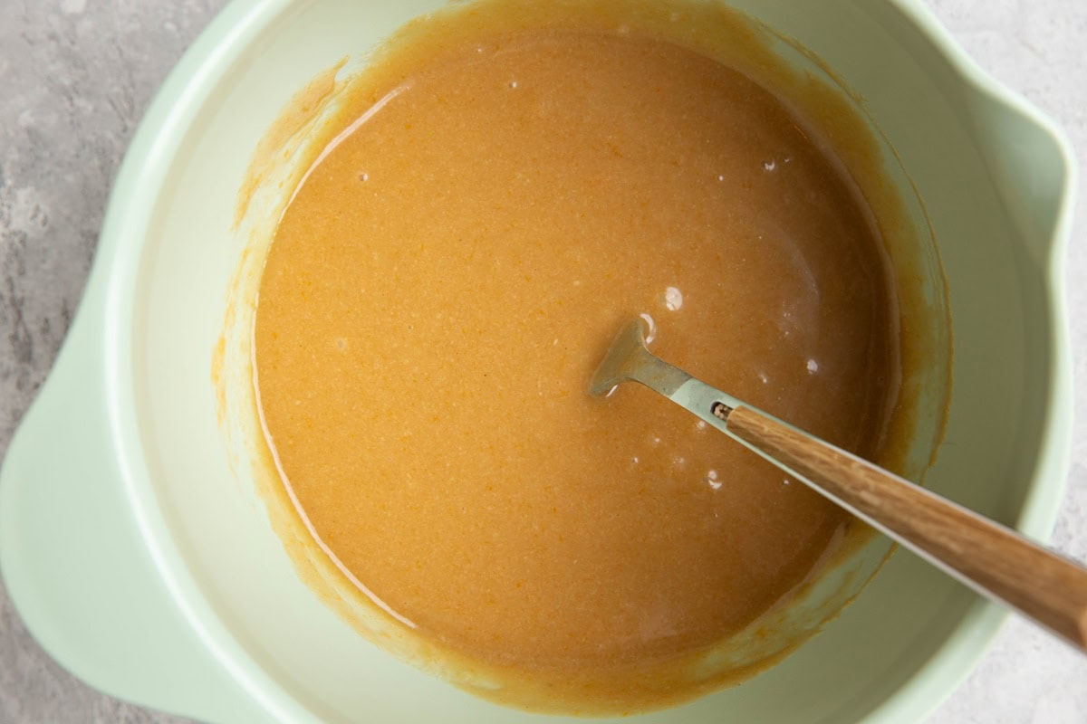 Wet ingredients for tahini cookies in a mixing bowl.
