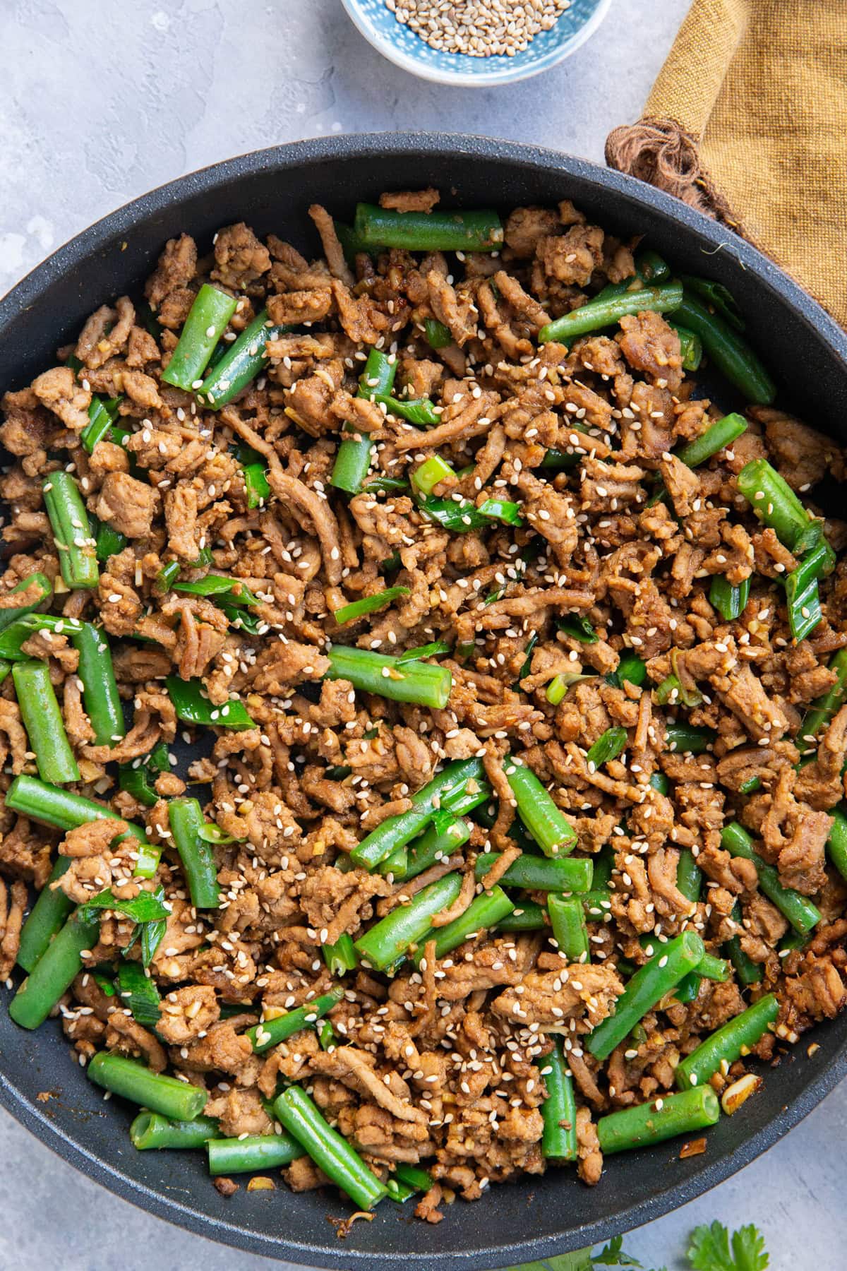 Large skillet full of ground turkey with green beans, ready to serve.
