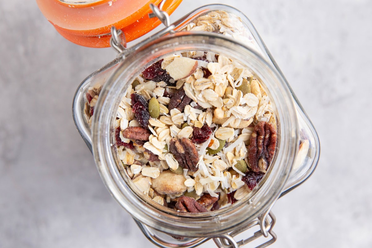 Large glass jar full of muesli mixture.