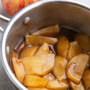 Saucepan full of stewed apples in sauce to use on ice cream, oatmeal, cake, etc.
