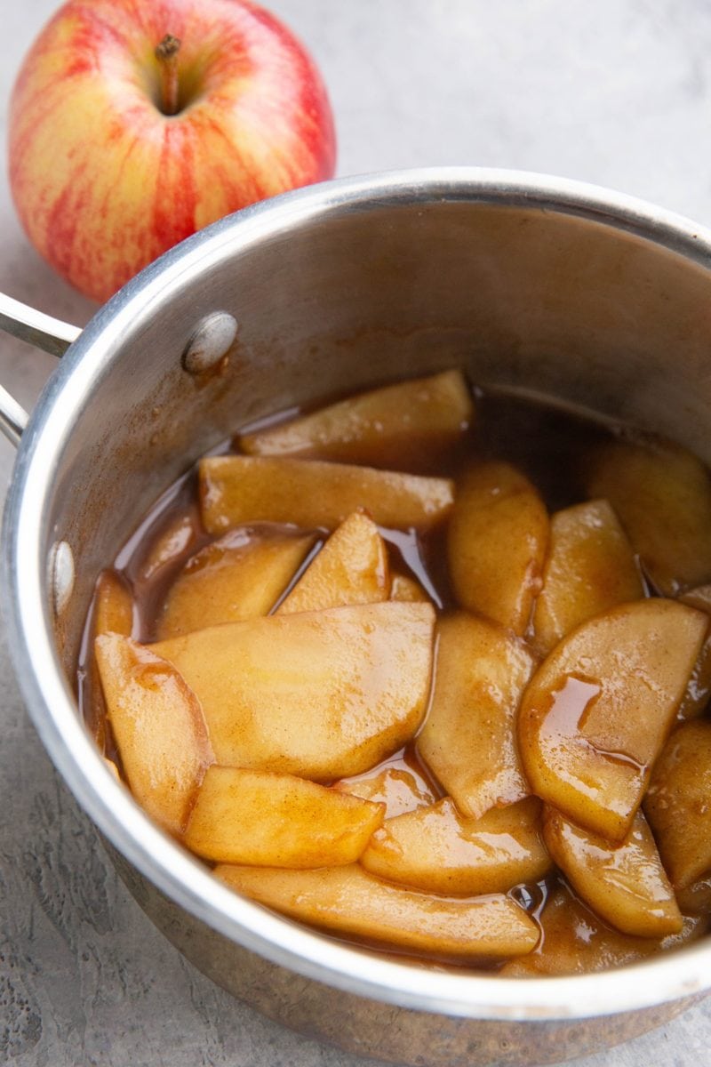 Saucepan full of stewed apples in sauce to use on ice cream, oatmeal, cake, etc.