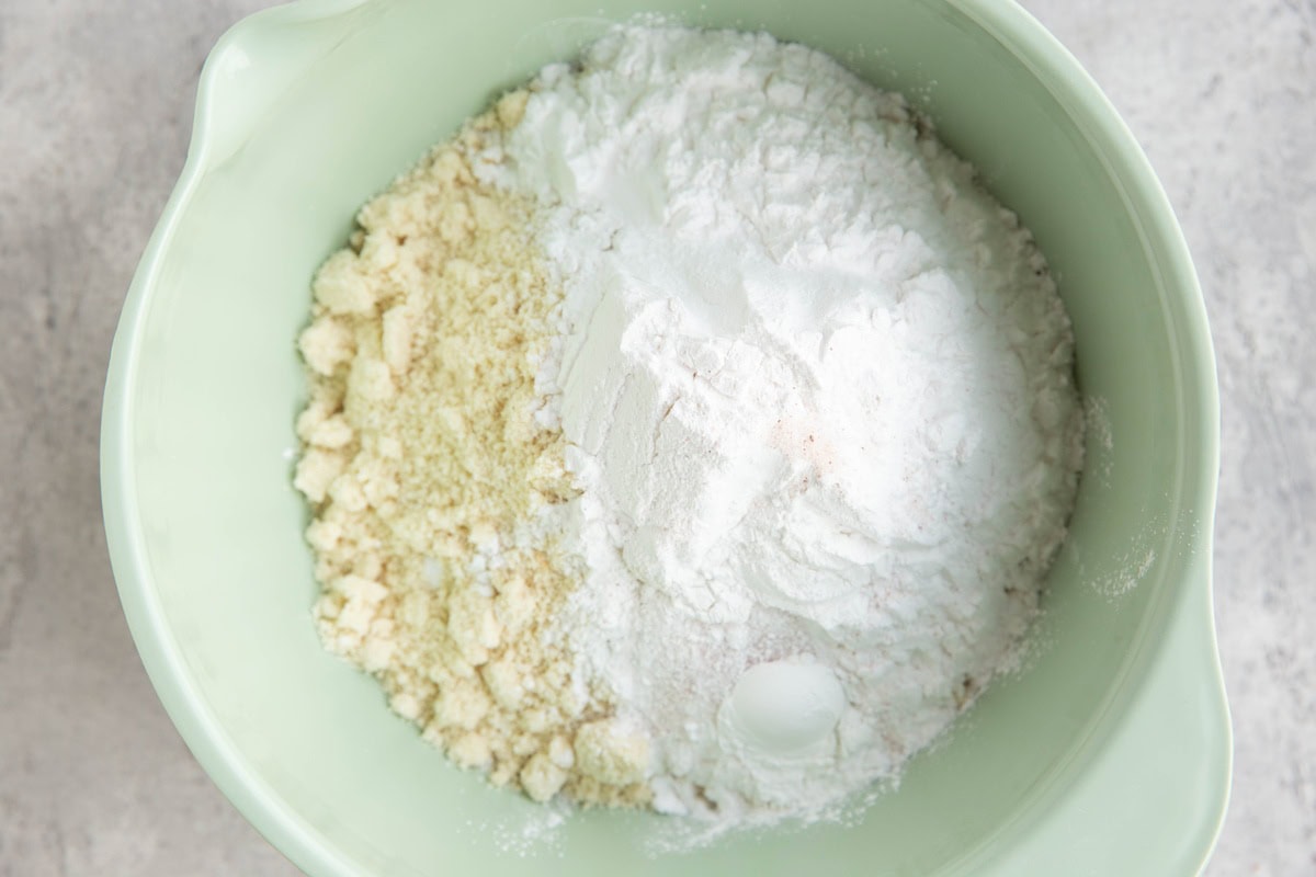 Mixing bowl with almond flour, tapioca flour, sea salt, baking powder, and baking soda.