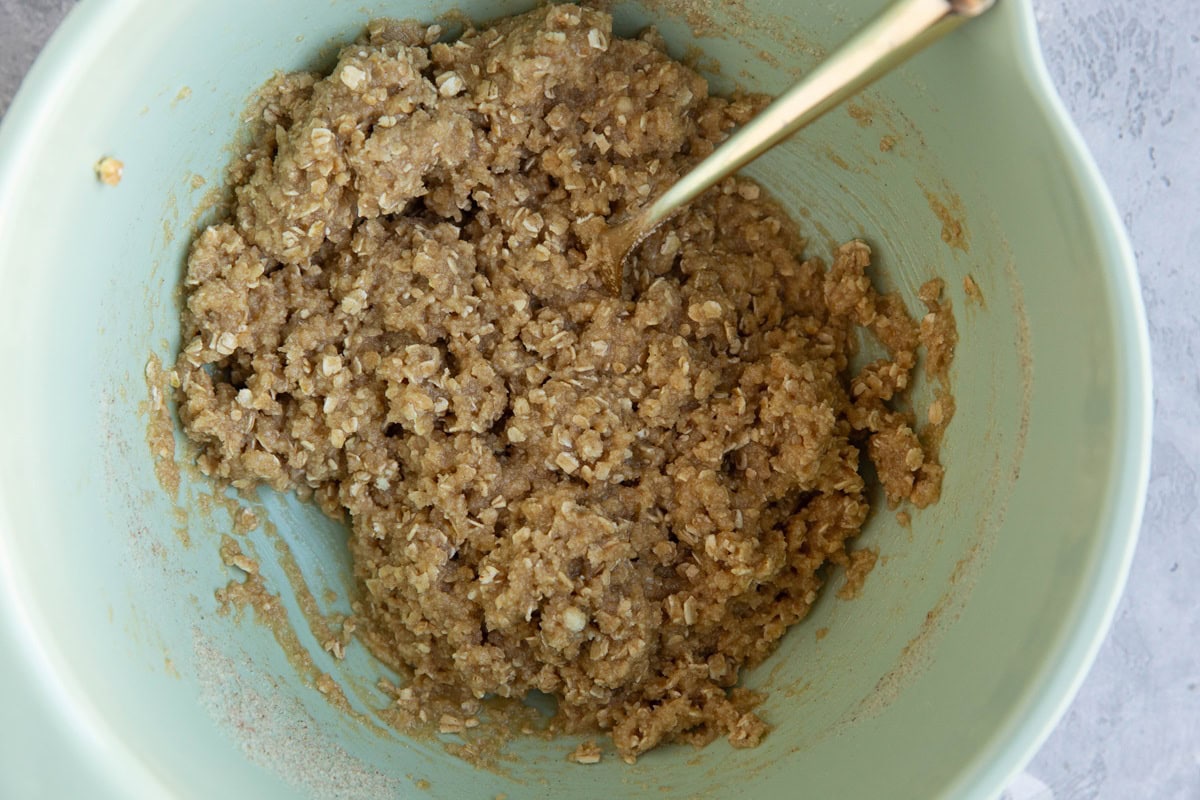 ALMOND FLOUR oatmeal cookie dough in a mixing bowl with a spoon. Ready to bake.