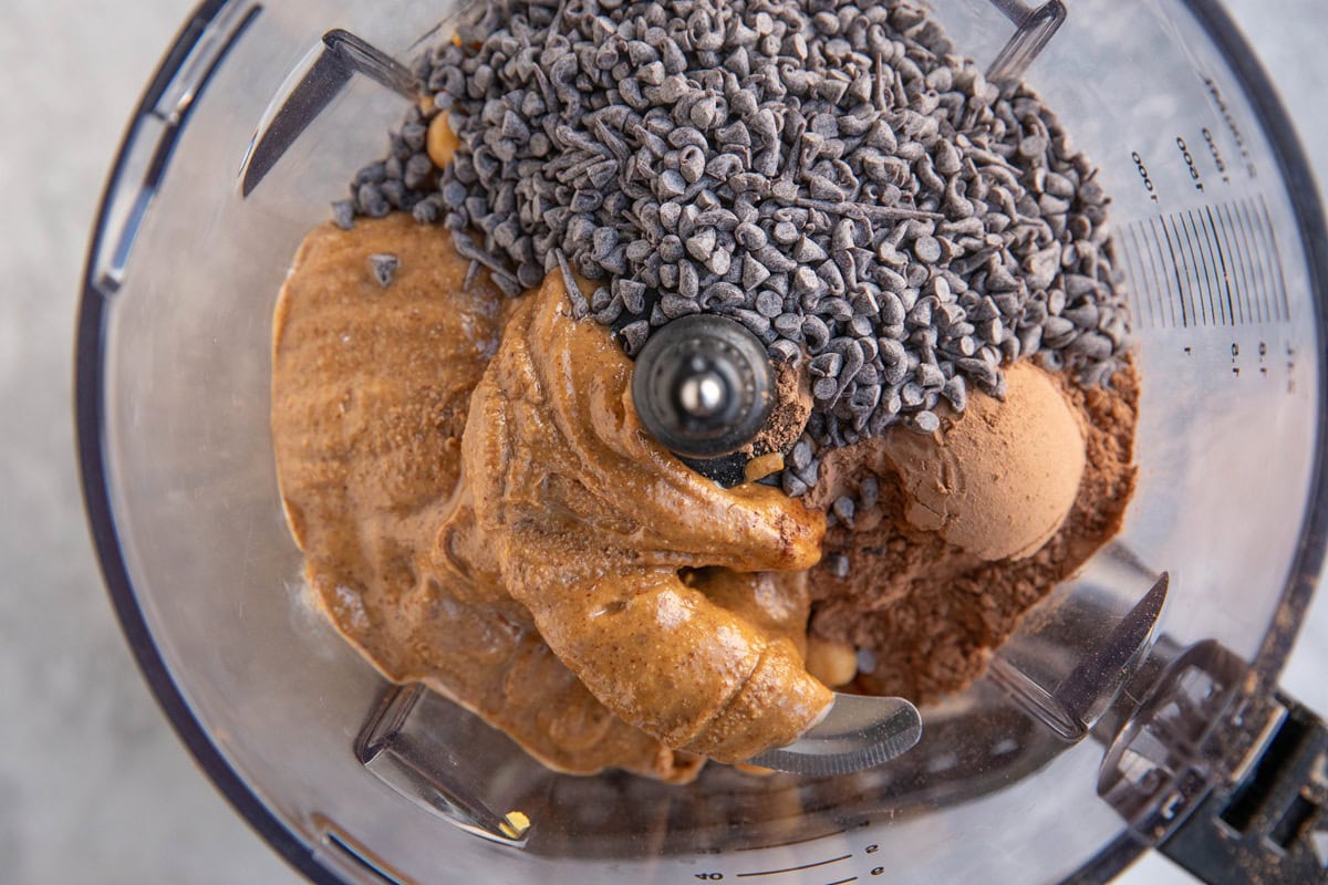 Food processor full of ingredients for chickpea truffles, ready to be blended up.