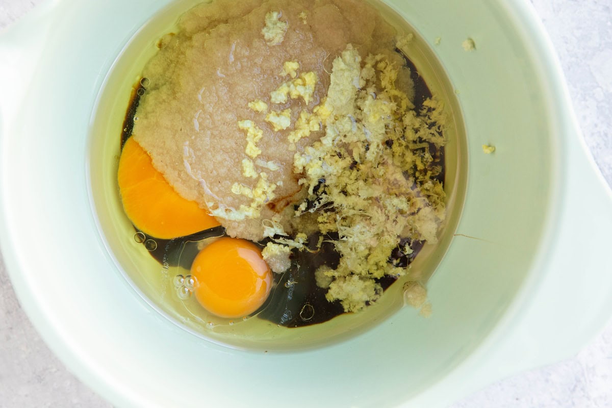 Applesauce, eggs, molasses, fresh grated ginger, and oil in a mixing bowl to be mixed up