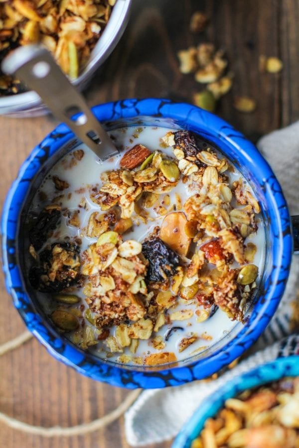 Bowl of granola with milk, ready to eat.