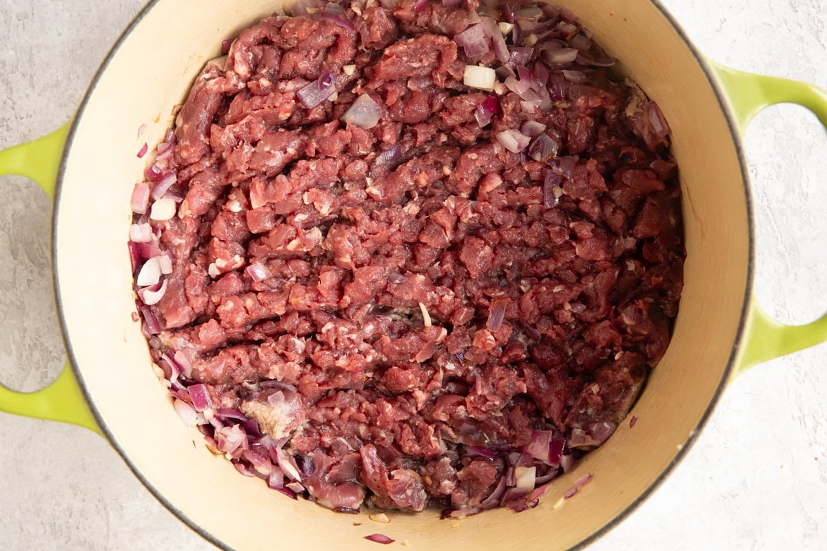 Large soup pot with ground elk cooking inside.