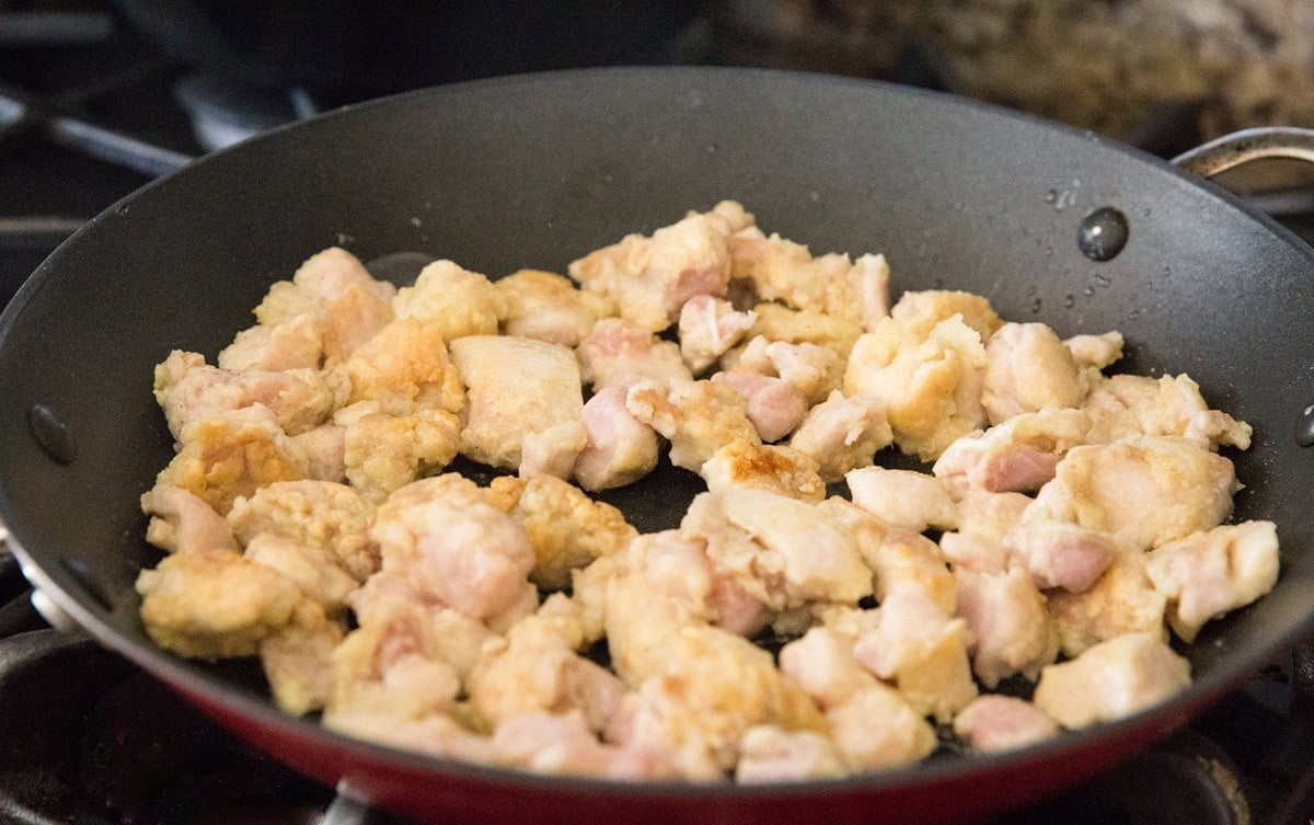 Skillet with breaded chicken pan drying to golden brown deliciousness.