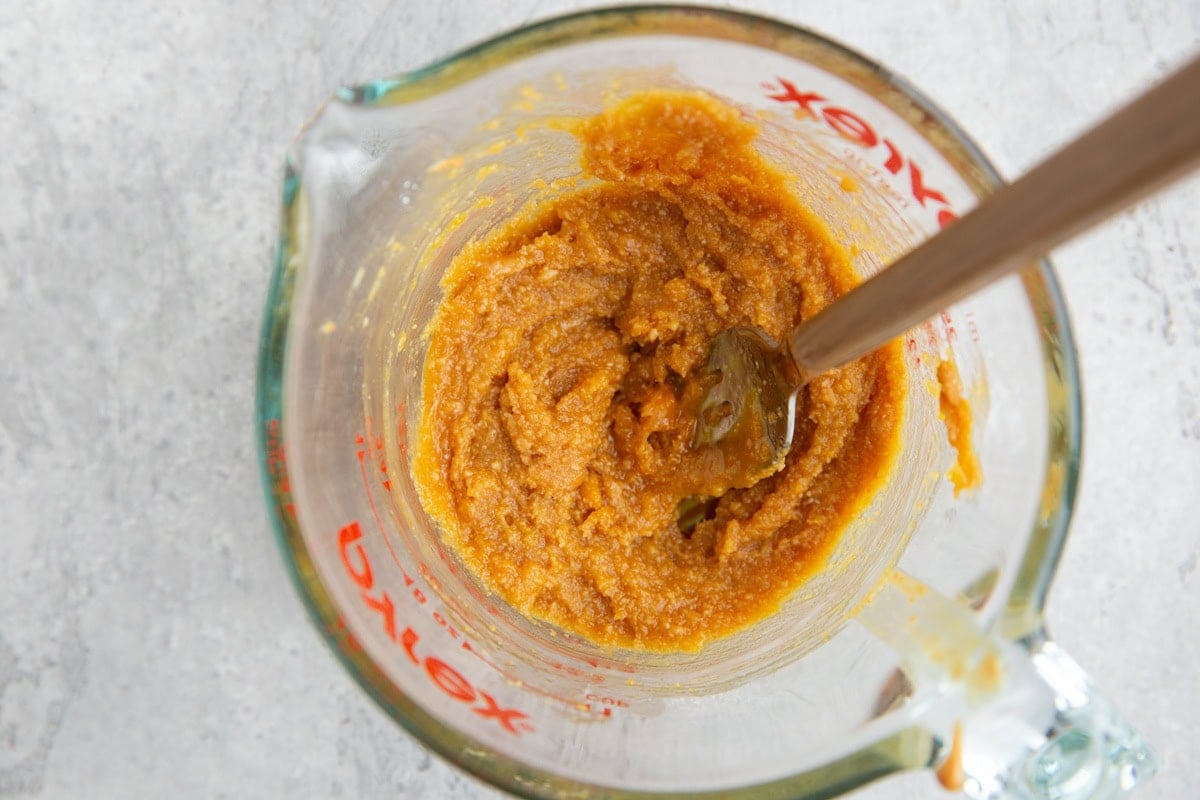 Peanut butter cake batter in a measuring cup.
