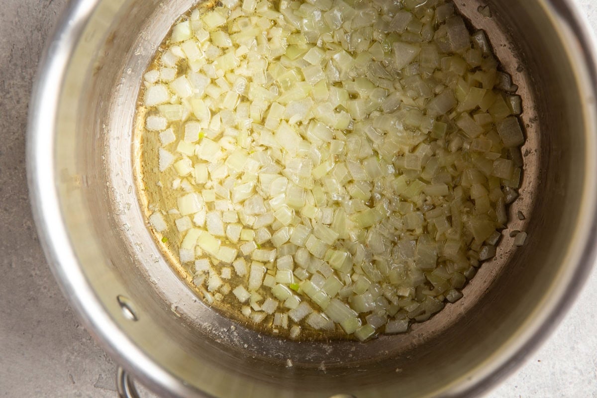 Saucepan with butter, oil, and finely chopped onion, sautéing to soften.
