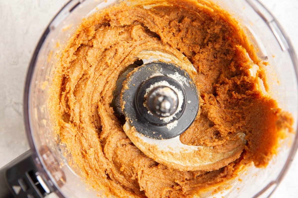 Food processor full of peanut butter cookie dough, mixed up and ready to use.