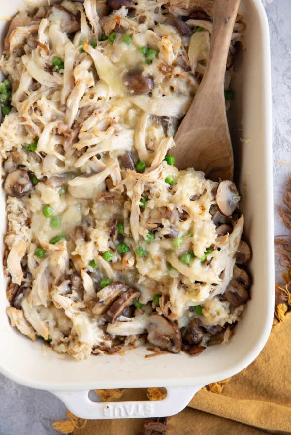 Large casserole dish full of rotisserie chicken casserole with a wooden spoon to the side, ready to serve.