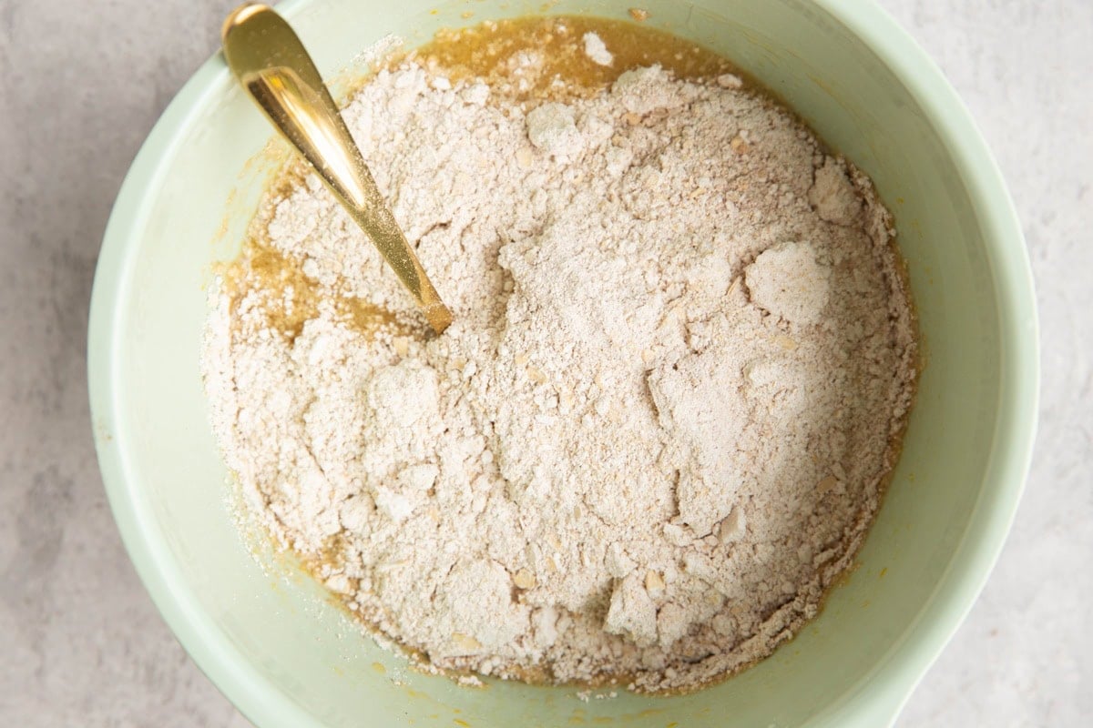 Mixing bowl with wet ingredients on the bottom and dry ingredients on top, ready to be mixed in.