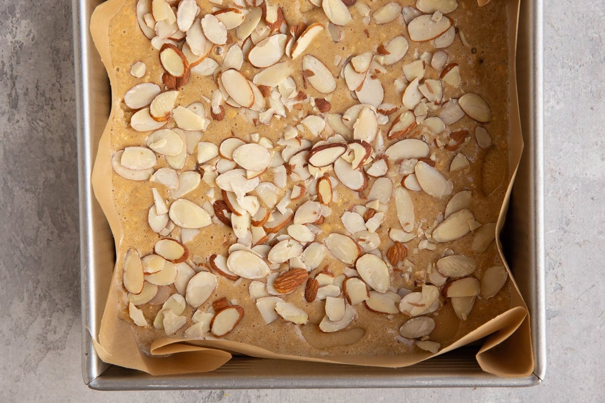 Bear claw cake ready to go into the oven sprinkled with sliced almonds.