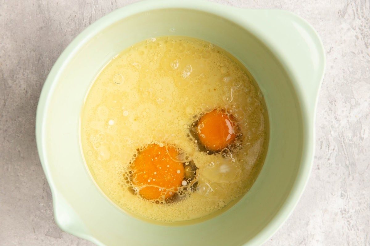 Wet ingredients for bear claw cake in a mixing bowl, ready to be mixed together.