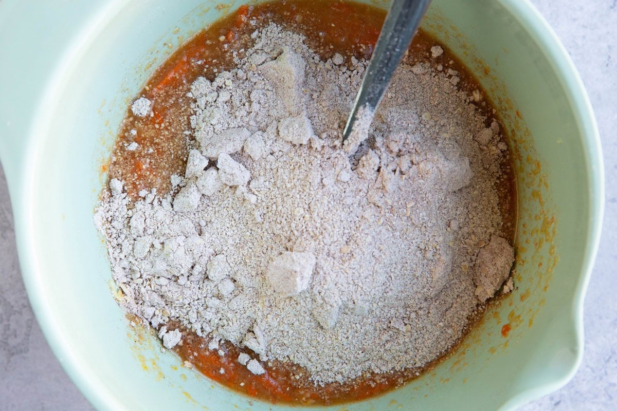 Dry ingredients on top of wet ingredients in a mixing bowl.