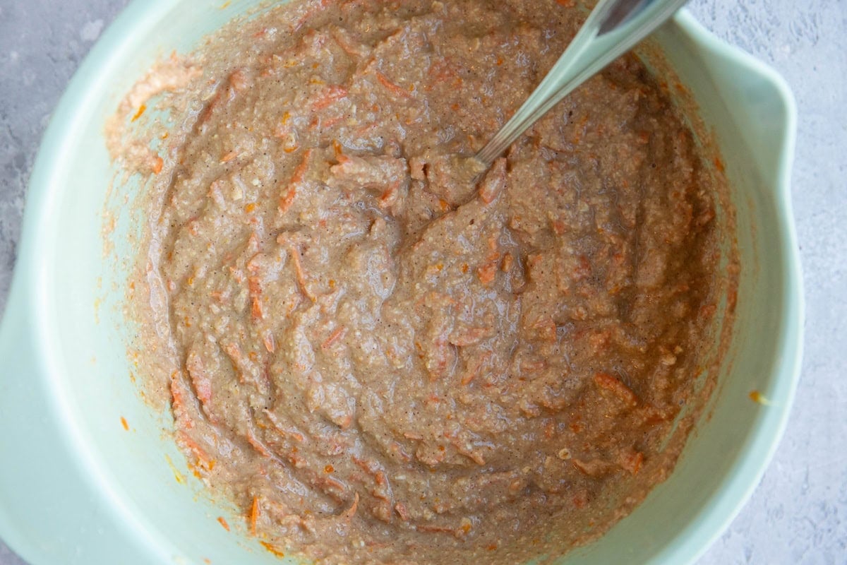 Mixing bowl full of carrot ginger orange muffin batter.