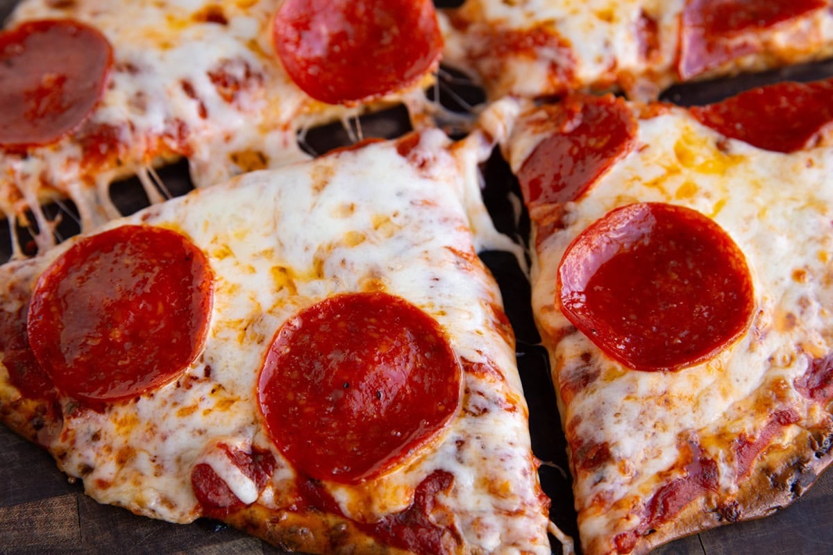 pepperoni pizza sliced into four slices, ready to serve.
