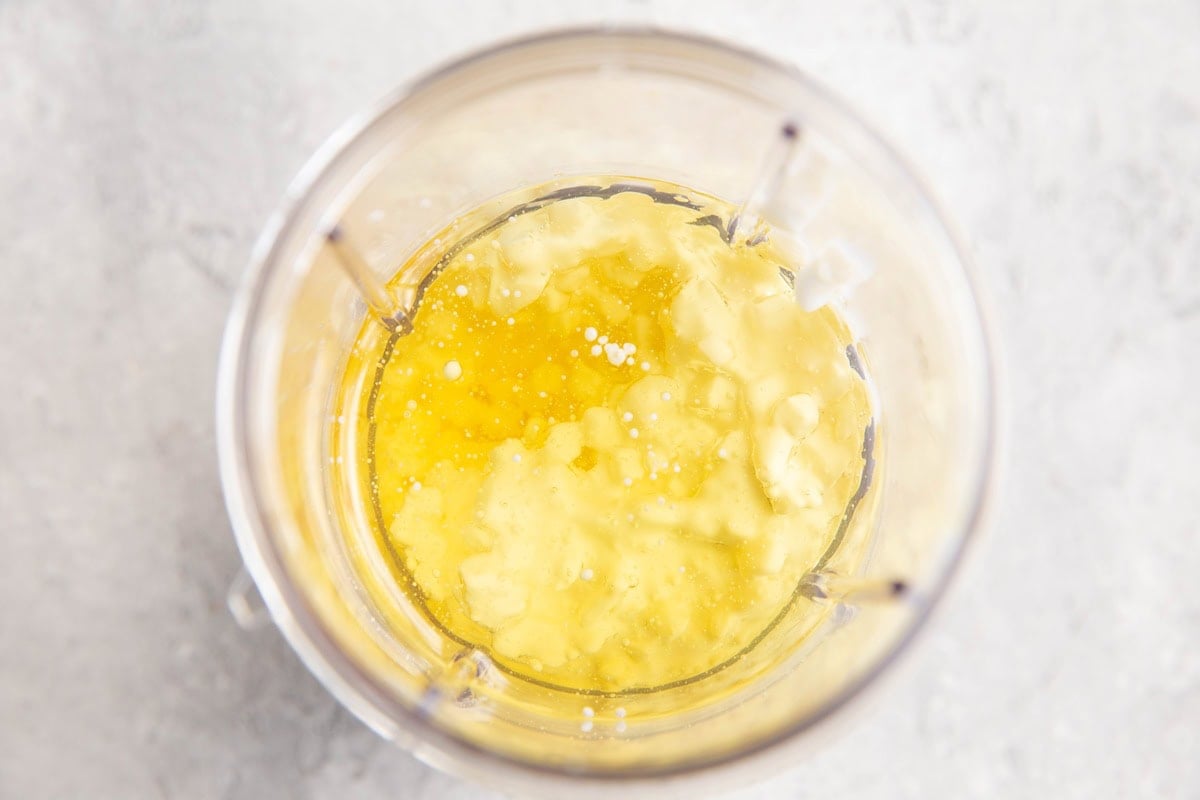 Small blender with cottage cheese and oil inside, ready to be blended.