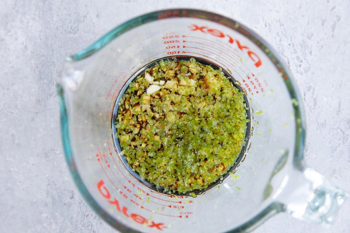 Measuring cup full of marinade for cod.