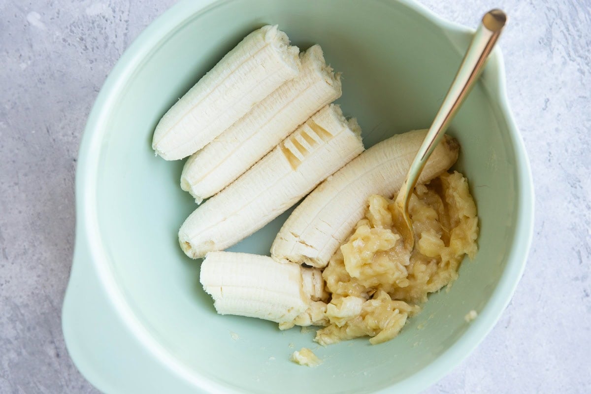 Three bananas in a mixing bowl