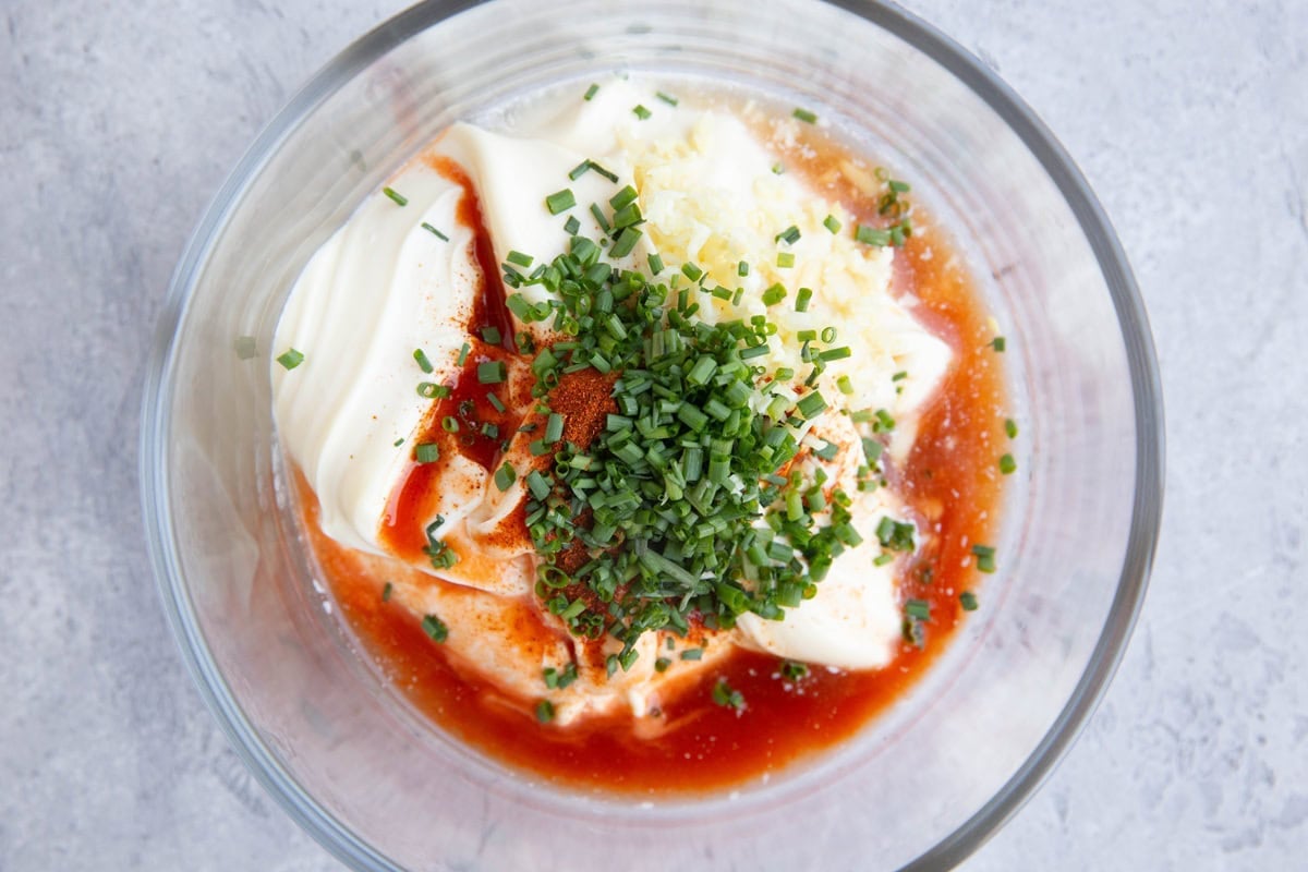 Ingredients for crab cake sauce in a small glass bowl. Ready to be mixed together.