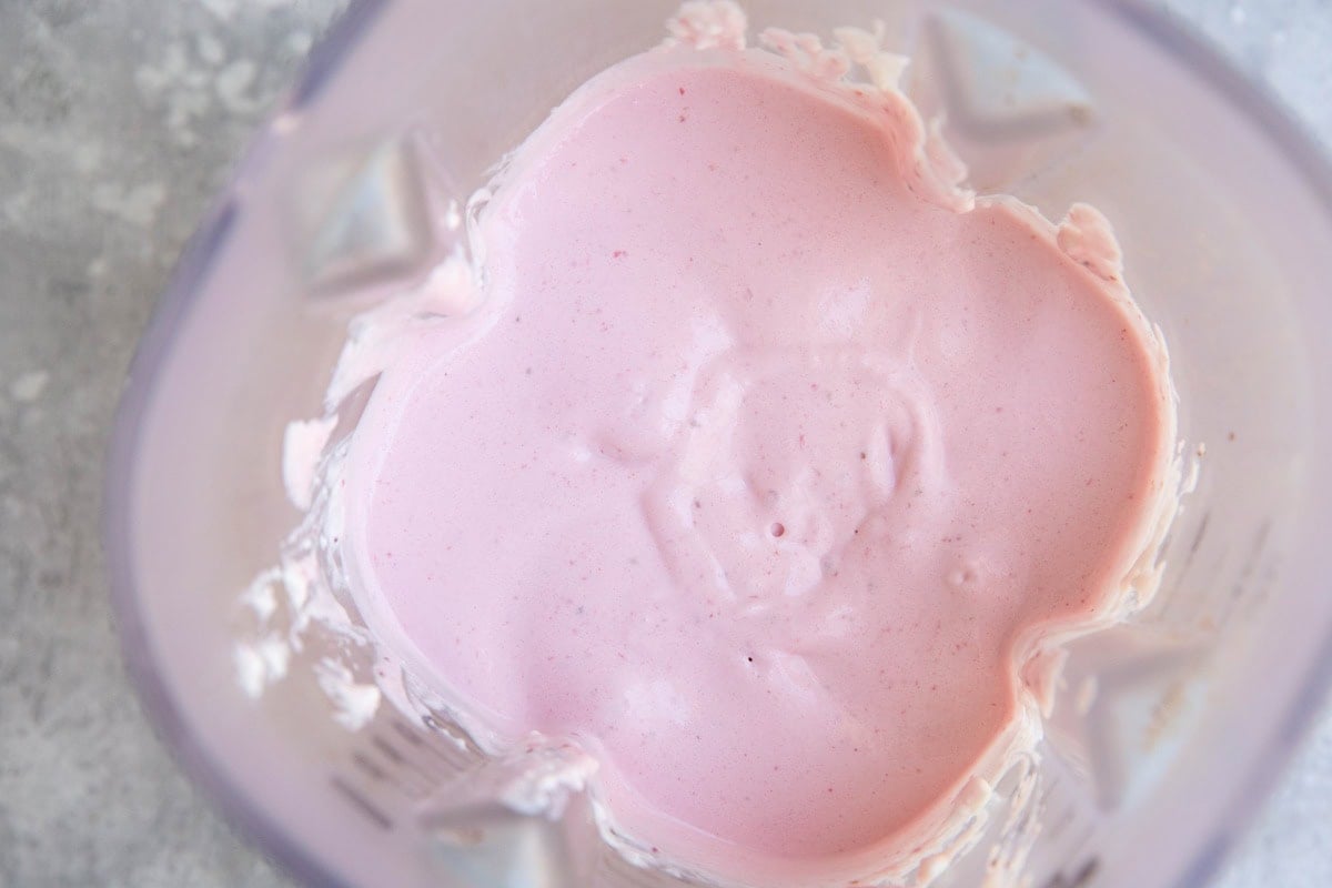 Thick creamy strawberry ice cream base in a blender
