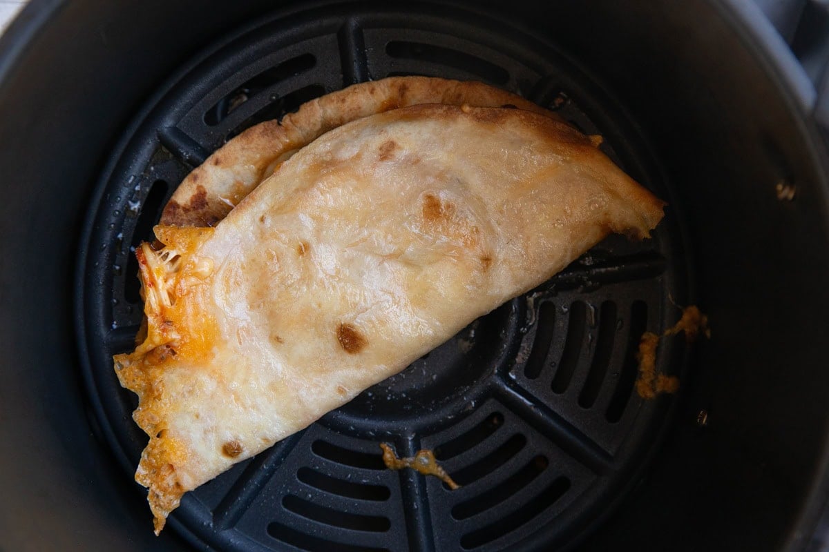 Air fryer with chicken quesadilla inside.