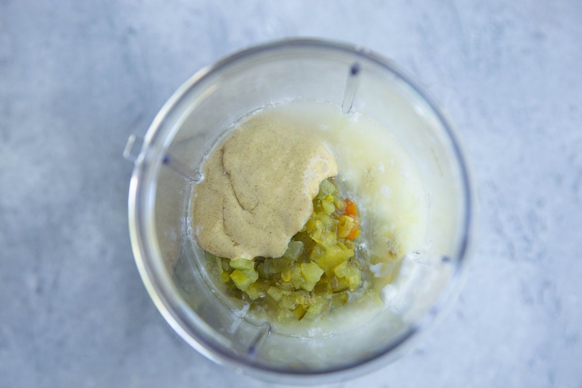 Cottage cheese, dijon mustard, relish, and salt in a blender to be blended for cottage cheese dressing.