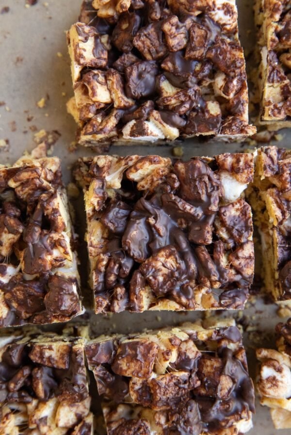 S'mores bars on a sheet of parchment paper cut into squares.