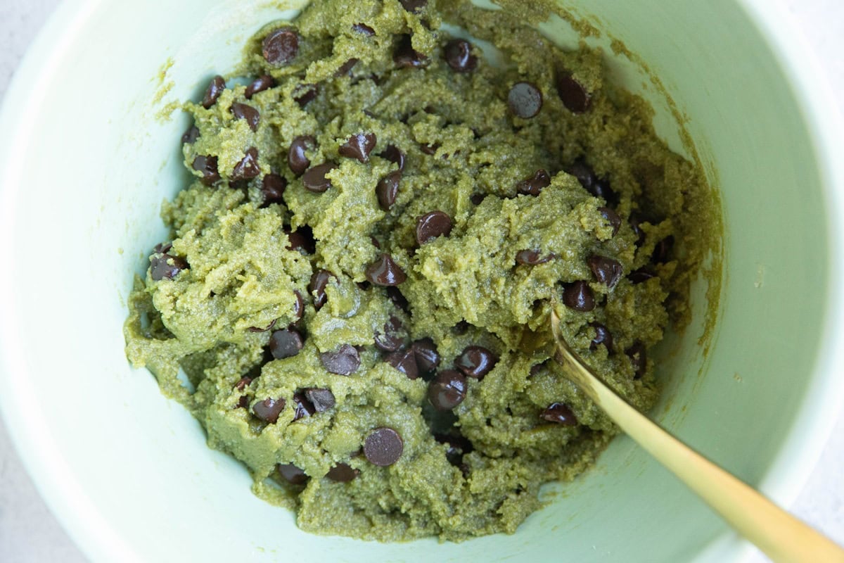 Pistachio butter cookie dough in a mixing bowl, ready to be baked.
