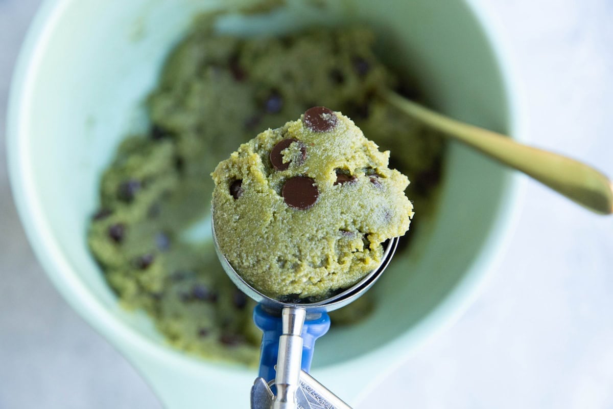 Cookie scoop with a scoop of pistachio cookie dough.