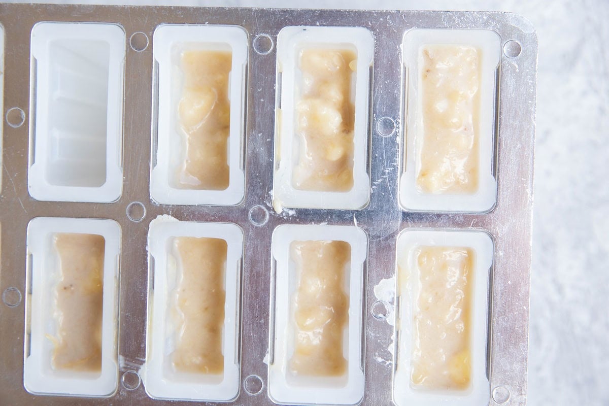 Popsicle mold full of banana mixture to make banana popsicles.