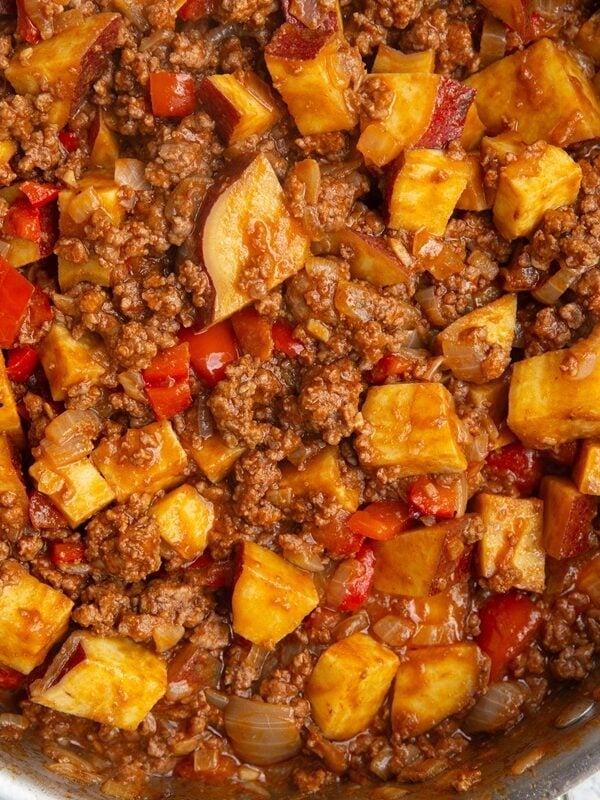 Stainless steel skillet with sweet potato sloppy joes mixture inside. Fully cooked and ready to serve.