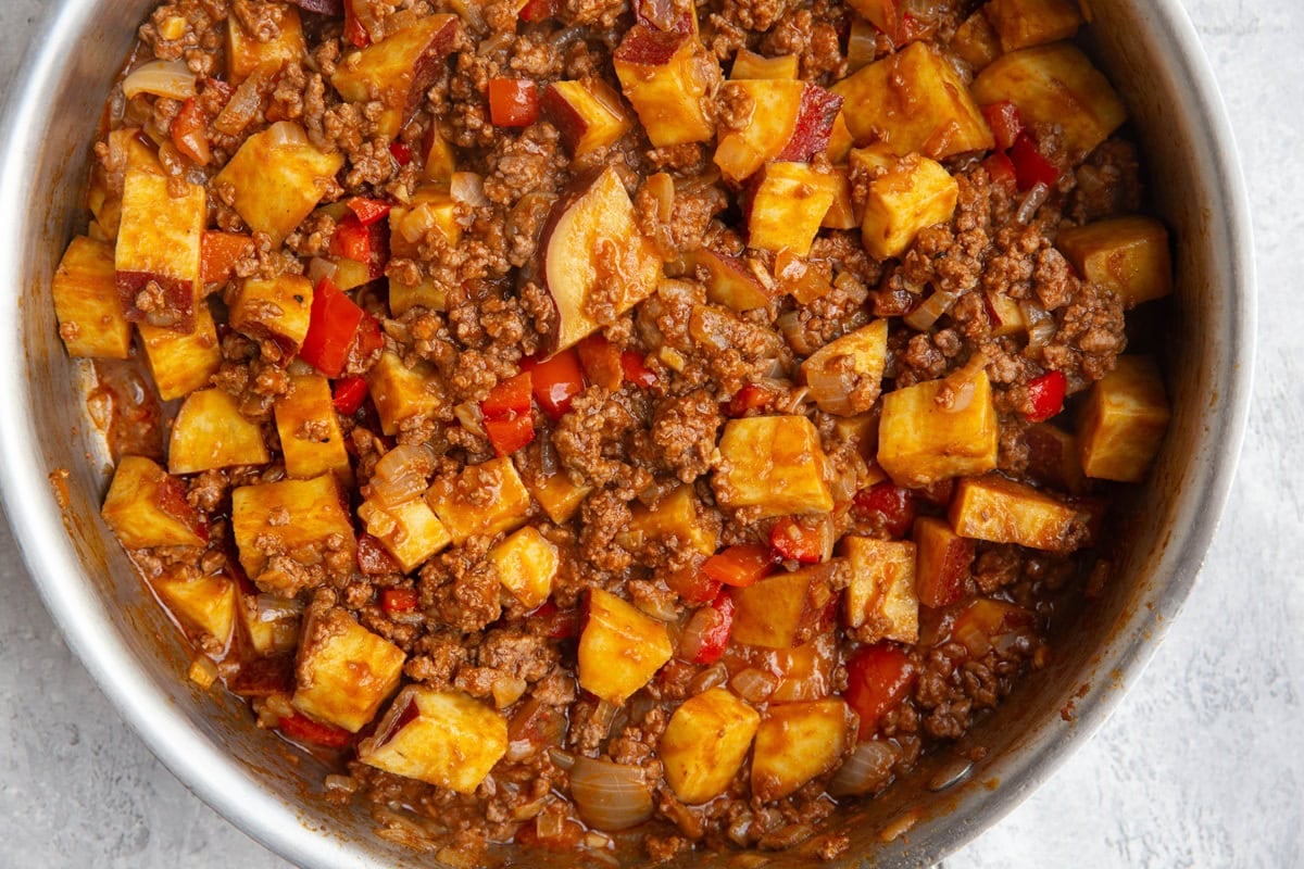 Stainless steel skillet with sweet potato sloppy joes mixture inside. Fully cooked and ready to serve.