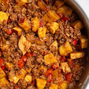 Skillet full of sweet potato sloppy joe mixture and cooked sweet potatoes, freshly made and ready to serve.