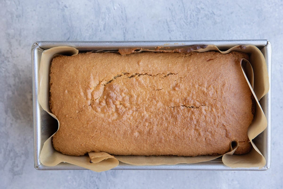 Loaf of bread in a bread pan, fresh out of the oven.
