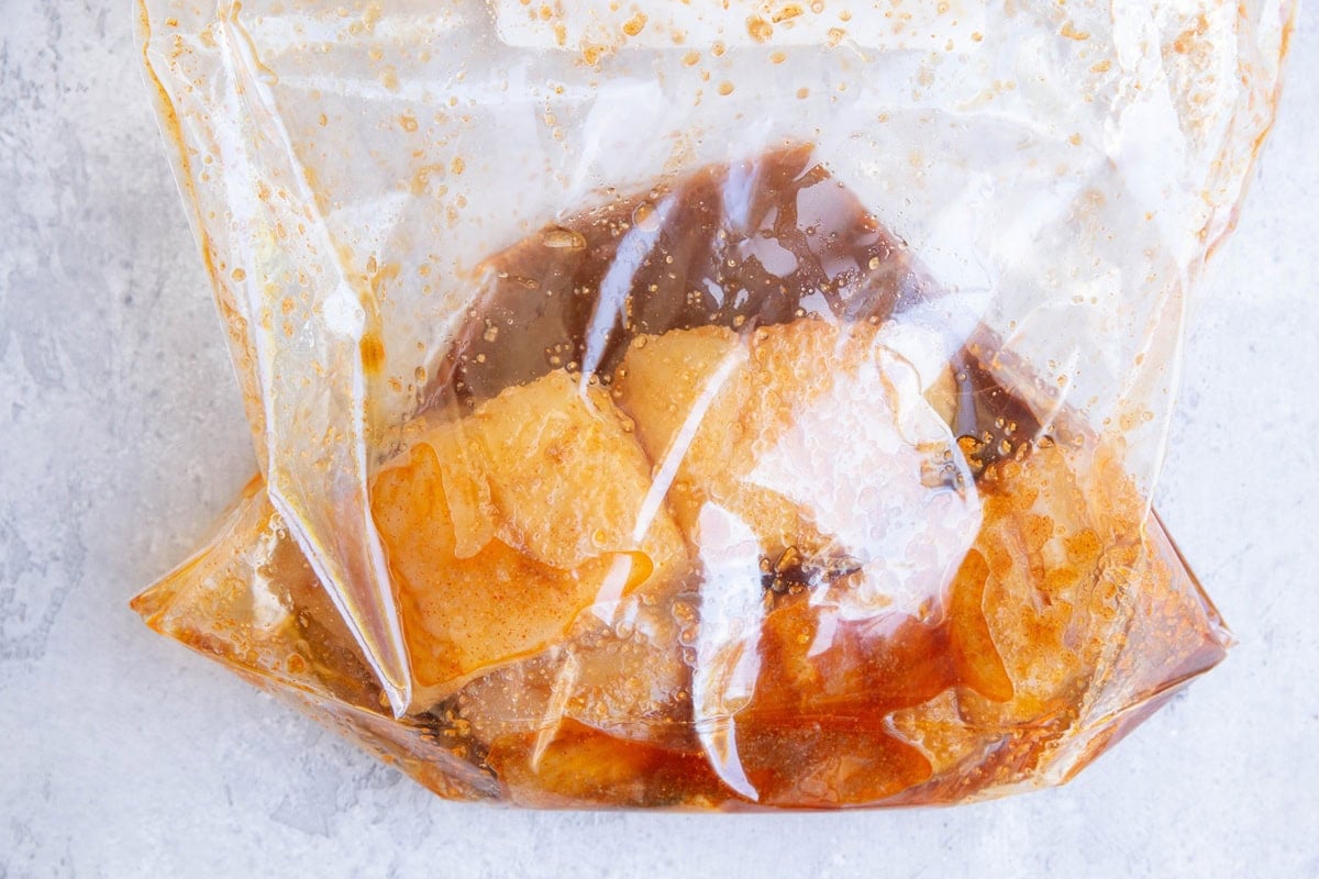 Zip lock bag with halibut marinating in a marinade.