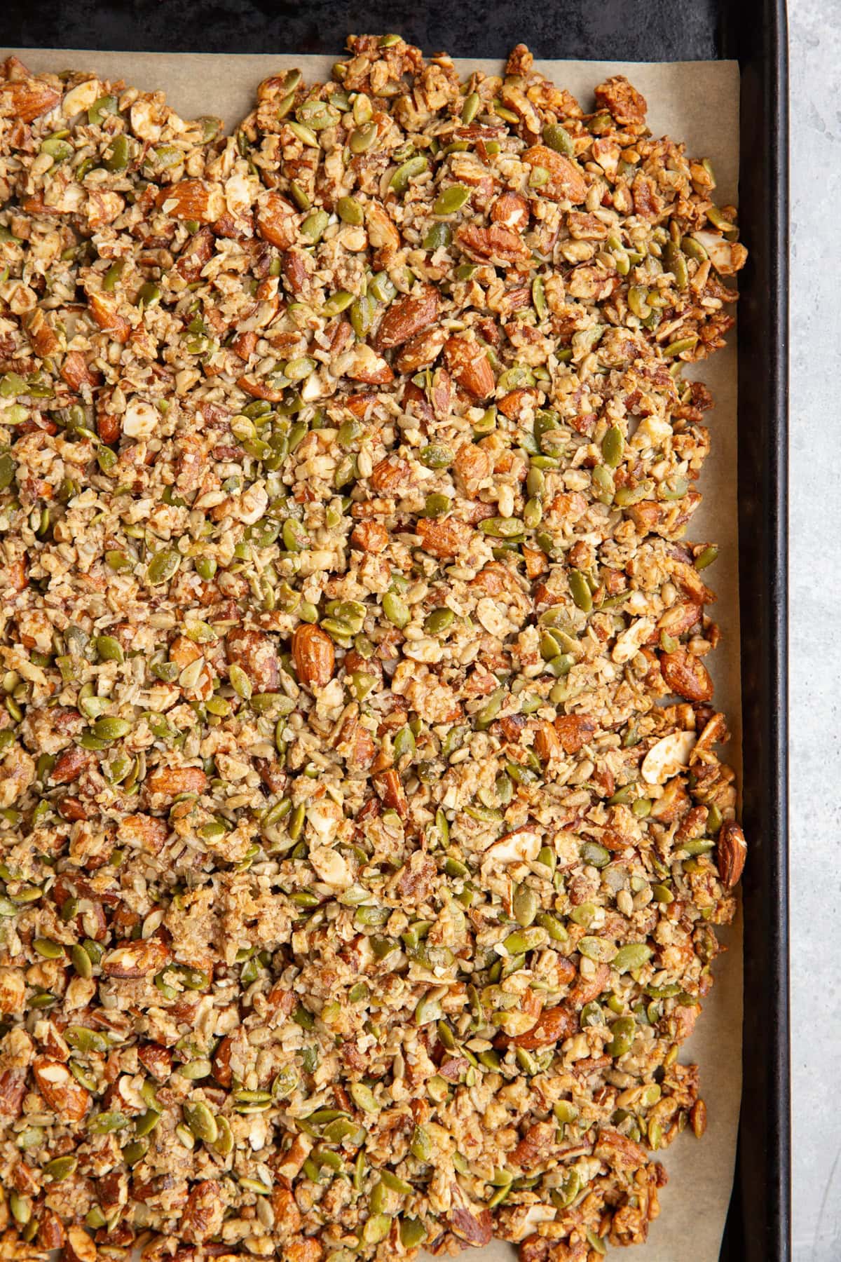 Baking sheet of nut and seed granola, fresh out of the oven.
