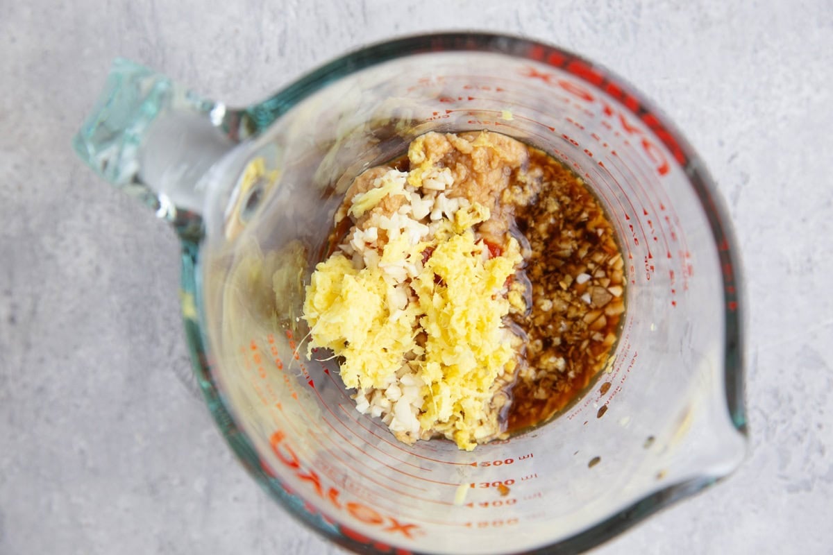 Measuring cup of sauce ingredients for miso salmon.