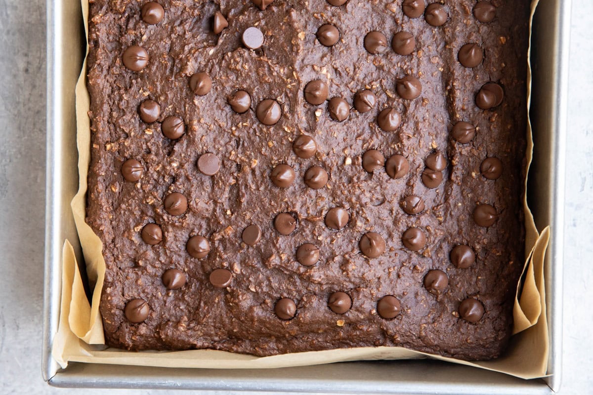 Baking pan full of chocolate sweet potato baked oats topped with chocolate chips, fresh out of the oven.
